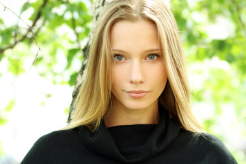 Naklejka premium Russian beauty - the happy girl at a white birch