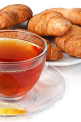 Fresh croissant and cup of tea