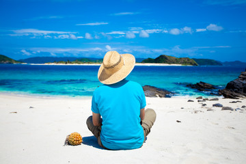 Man looking at coral island of Okinawa - 14019901