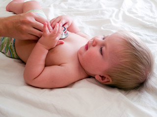 medical examination of baby with stethoscope