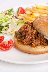 minced meat burger with french fries and salad