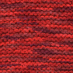Red colors knitted wool line close up.