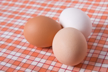 three eggs on table cloth