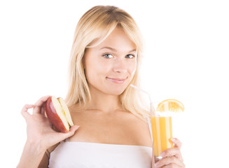 Young blonde girl with an apple and a glass of juice