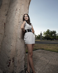 Young female posing on a wall