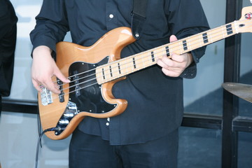 a person playing a bass guitar