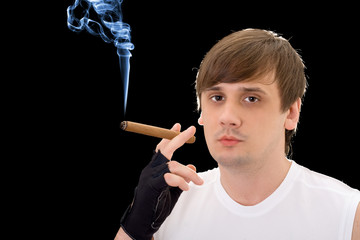 Fototapeta premium Portrait of the young man with a cigar