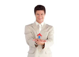 Businessman holding a house