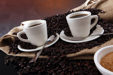 Fresh brewed coffee on grains and sisal sack