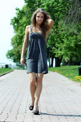 Obraz premium Portrait full growth - young beautiful girl rest in park