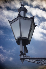Fototapeta na wymiar Old style street lantern with cloudy sky