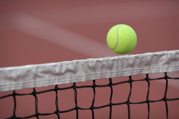 Tennis ball going over the net during a tennis match