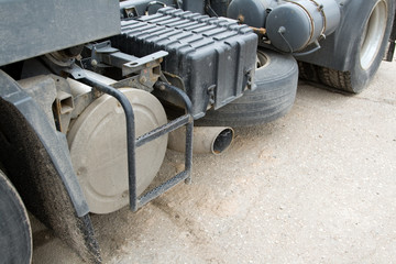 Close - up of a dirty heavy truck`s muffler.
