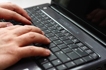 Typing on a laptop computer