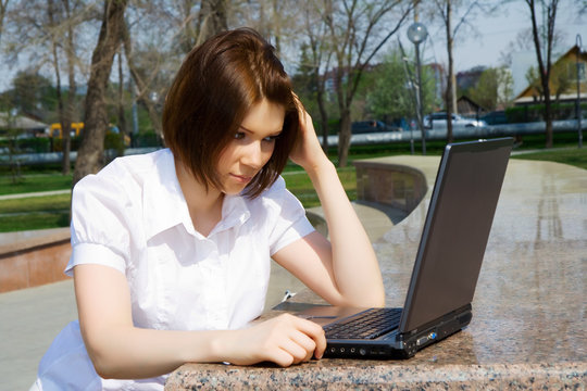 Young woman working on laptop.
