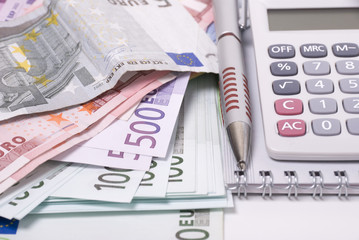 Money, pen and calculator