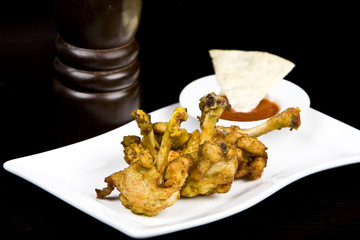 to fry chicken wings, on a black background