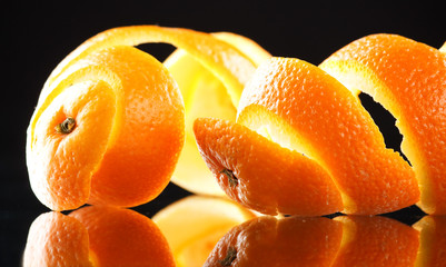 Spiral orange peel reflecting on black background
