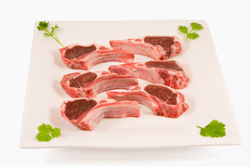 Raw lamb chops on a plate