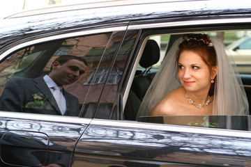 Bride with groom reflexion in a windowpane