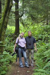 Father and Daughter walking through an old-growth Rainforest