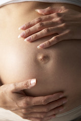 Detail Of Pregnant Woman Holding Stomach