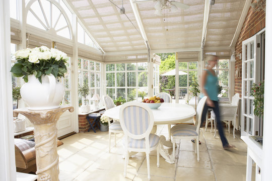 Woman Walking Through Conservatory