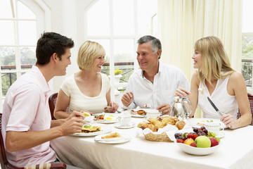 Obraz na płótnie Canvas Family Group Enjoying Hotel Breakfast