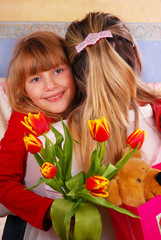 Obraz na płótnie Canvas girl with bouquet of tulips for mummy