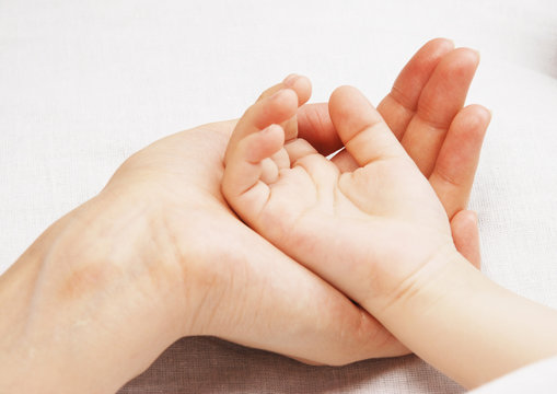 Hand of the child in a hand of mother