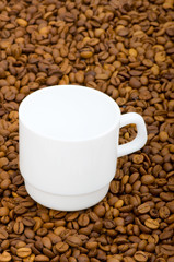 White cup and background of coffee beans