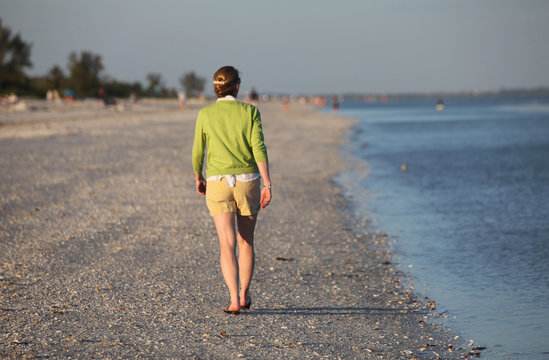 woman walking along beach