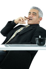 Confident businessman smoking cigar