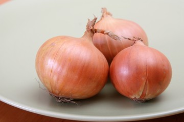Three onions on plate