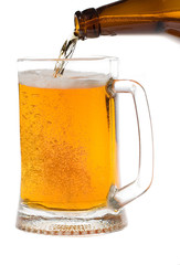 Beer is poured in a mug on white background