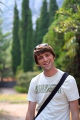 Portrait of a smiling adult man in a tropical garden