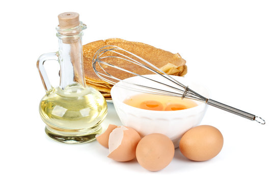 Eggs, oil, pancakes and whisk