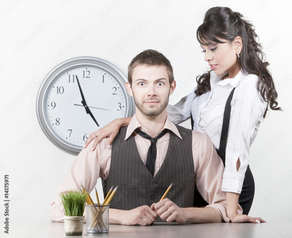 Wall mural man receiving attention from a pretty coworker