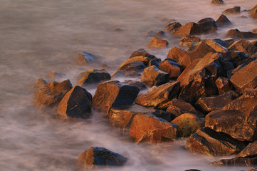 Misty ocean water and rocks at sunrise in North Carolina