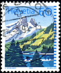 Helvetia. Paysage suisse, lac montagnes et forets. Timbre.