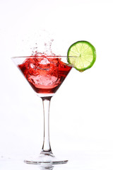 red cocktail with lime on white
