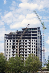 Fototapeta na wymiar Residential building construction with crane and sky