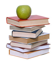Green apple on pile of books on white background