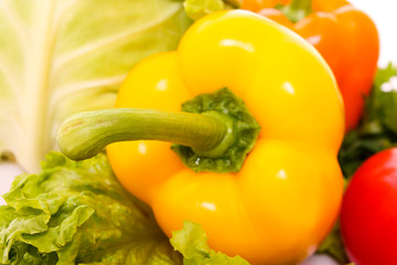 Orange pepper on vegetables background