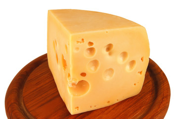big chunk of yellow cheese on wood plate