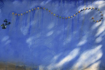 Grunge blue mediterranean garden wall shadows