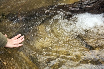 hand woman touching river