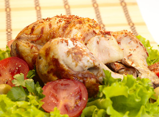 grilled chicken whole with vegetables on salad leafs