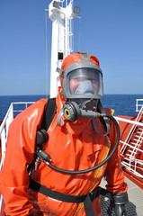 man in chemical suit on deck of chemical tanker - 14226123