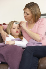 Mother Taking Temperature Of Sick Daughter